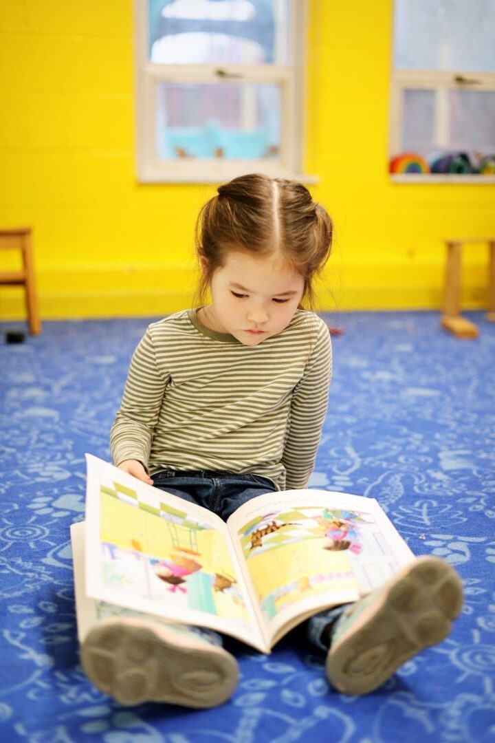 a preschooler reading a book